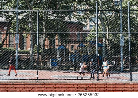 New York, Usa - May 30, 2018: Teenagers Play Basketball On A Public Court In Brooklyn, New York, On 