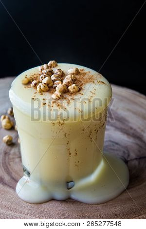 Boza Or Bosa Drink Flows From A Glass With Roasted Chickpea.