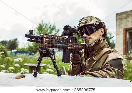 Military Man With Automatic Rifle And Rifle Scope