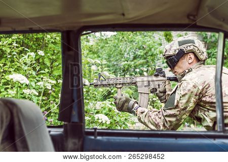 Military Man With Automatic Rifle And Rifle Scope