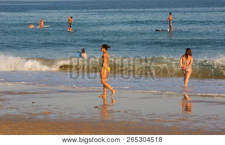 VILA DO BISPO, PORTUGAL - AUGUST 21, 2018: People at the famous beach of Salema in Vila do Bispo. This beach is a part of famous tourist region of Algarve.