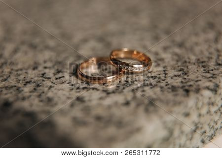 Wedding Rings On Table. Gold Rings With Diamond On Sun. Wedding Accsessories. Macro