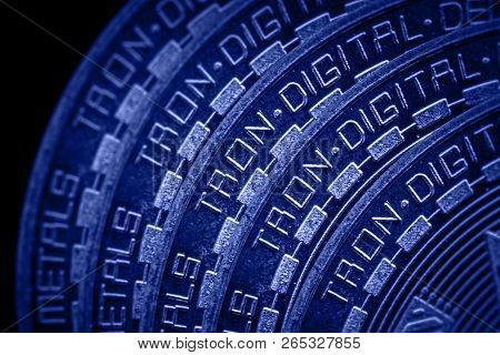 Coin Cryptocurrency Tron Closeup On Blue Black Background.
