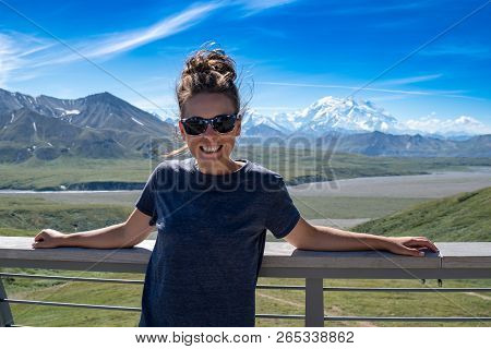 Adult Female Stands In Front Of Denali Mountains In The Alaska Range Of Denali National Park. Concep
