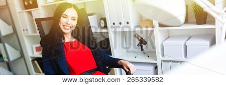 A Beautiful Young Girl Leaned Back In Her Office At The Table.