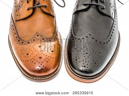 A Close-up Shot Of A Pair Of Mens Brown And Black Wingtip Dress Shoes On An Isolated Background