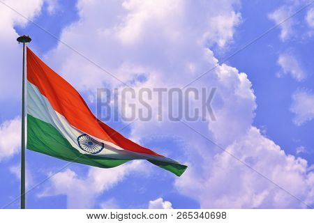 Indian Flag Tiranga Waving In The Blue Cloudy Sky