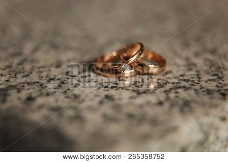 Wedding Rings On Table. Gold Rings With Diamond On Sun. Wedding Accsessories. Macro