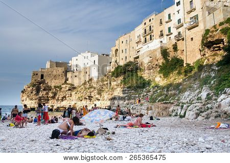Polignano A Mare, Italy - July 6 2018: People On Lovely Beach Lama Monachile, Adriatic Sea, Apulia,