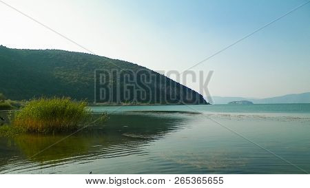 Coast Of Lake Prespa And Mountains Of Galicica National Park.