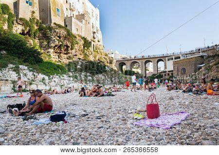 Polignano A Mare, Italy - July 6 2018: People On Lovely Beach Lama Monachile, Adriatic Sea, Apulia,