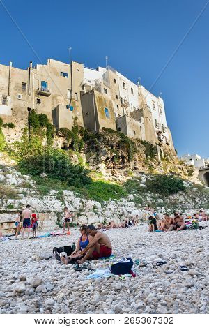 Polignano A Mare, Italy - July 6 2018: People On Lovely Beach Lama Monachile, Adriatic Sea, Apulia,