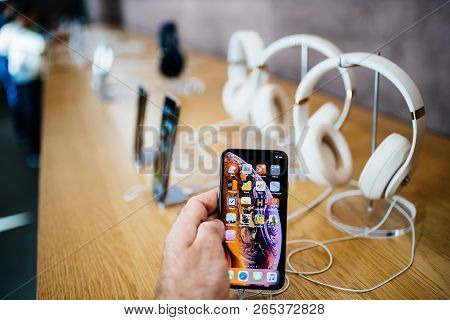 Paris, France - Oct 26, 2018: Man Hand Holding New Iphone Xs Xr Max With Apple Music App And Multipl