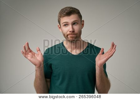 A Handsome Man Does Not Know The Answer To The Question, Hesitates, Isolated On White Background. Th
