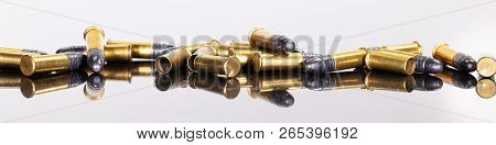 Panorama With A Group Of Ammunition On A Table With Reflections, White Background