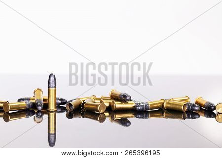 Group Of Ammunition On A Table With Reflections, White Background
