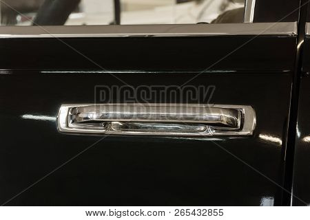 Background - Door With A Shabby Chrome Door Handle Of A Vintage Black Car