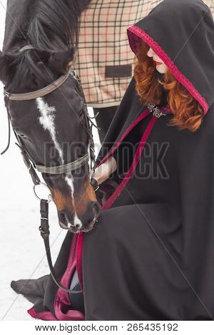 Halloween Witch With A Horse In The Snow