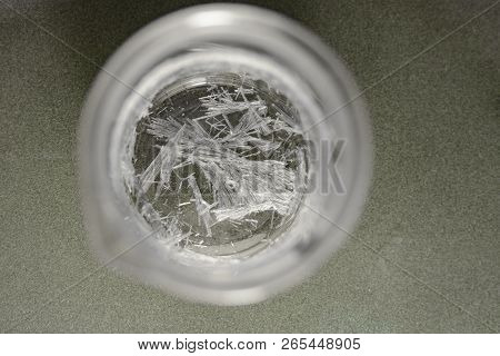 Chemical Glass With Crystals Of Salicylic Acid On A Matte Glass