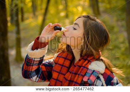Sneezing Young Girl With Nose Wiper Among Yellow Trees In Park. Young Woman Blowing Nose At Nature. 