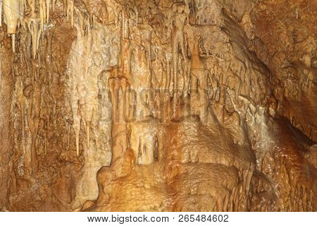 Natural Texture Photo Of Pretty Natural Cave With Gingery Walls And Formations Of Stalagmites And St