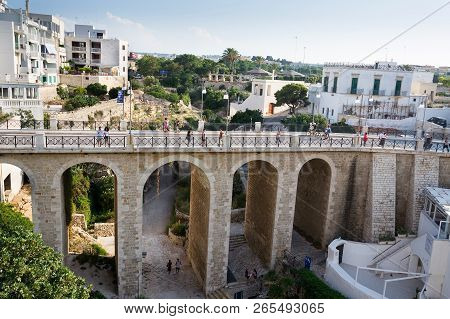Polignano A Mare, Italy - July 6 2018: People On The Ponte Lama Monachile Bridge, Adriatic Sea, Apul
