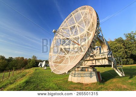 Satellite Dish In A Summer Landscape, Sky Background.