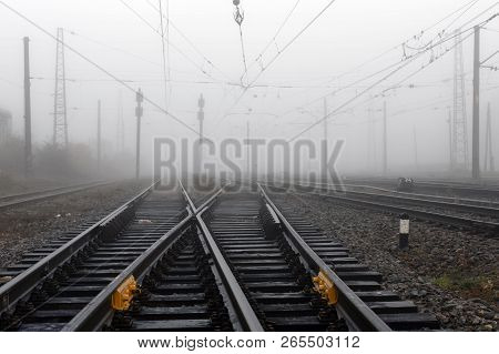 Crossing Railways  Fading Away Disappearing In The Mist In Autumn Morning