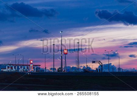 Taman, Russia - October 2018: Lukoil Gas Station On The Crimean Bridge At Sunset, Night. Lukoil Is A