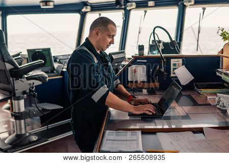 Marine Navigational Officer Is Using Laptop Or Notebook At Sea