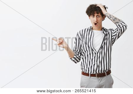 Studio Shot Of Man Being Robbed And Punched In Head Pointing Left At Thiefs Telling Police What Happ