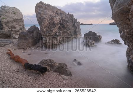 Dusk On The Beach Immediately After Sundown, Big Rocks, Turquoise Water Of Ionian Sea, Milky Waves A