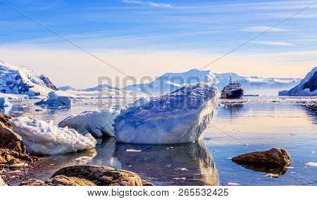 Touristic Antarctic Cruise Ship Among The Icebergs With Glacier In Background, Neco Bay, Antarctica