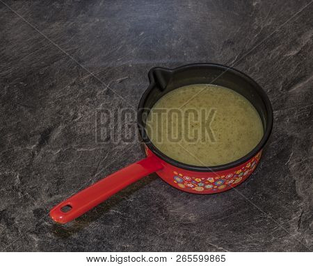 Cooking Of Marijuana Green Butter In Hot Water In Kitchen