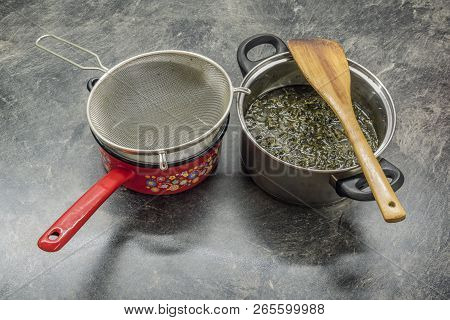 Cooking Of Marijuana Green Butter In Hot Water In Kitchen