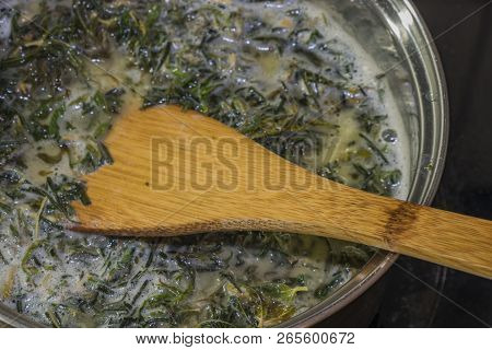 Cooking Of Marijuana Green Butter In Hot Water In Kitchen