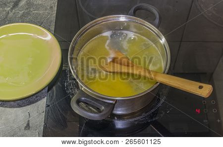 Cooking Of Marijuana Green Butter In Hot Water In Kitchen