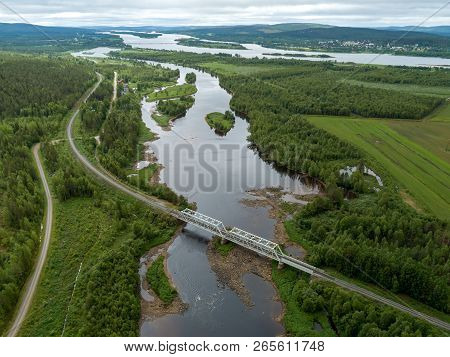 Steel Railroad Bridge Over River In Northern Finland Seen From The Sky
