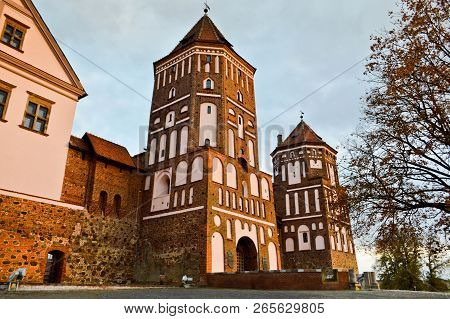 Old, Ancient Medieval Castle With Spiers And Towers, Walls Of Stone And Brick Surrounded By A Protec