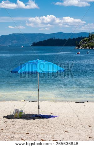 Umbrella On A Sandy Beach In South Lake Tahoe, California In Emerald Bay.