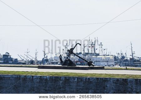 Anchor On The Sea Promenade Overlooking The Port