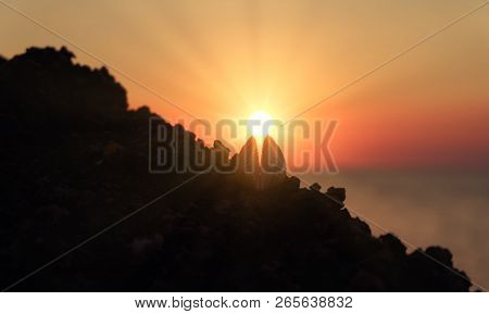 Open Sea Shell Lying On Rocky Coast With Setting Sun Between Valves