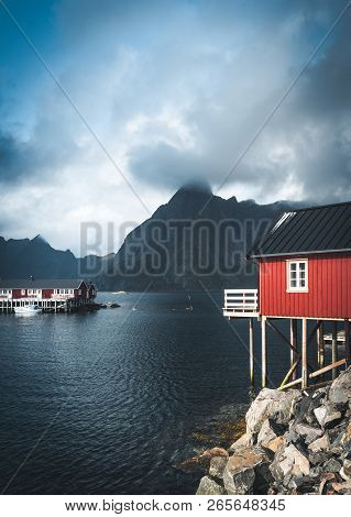 Rainbow Ofer Red Houses Rorbuer Of Reine In Lofoten, Norway With Red Rorbu Houses, Clouds, Rainy Blu