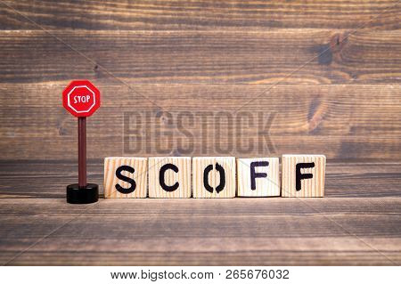 Stop Scoff Concept. Wooden Letters With Road Sign On Wooden Background