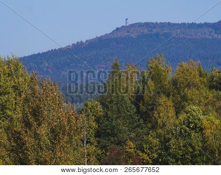Meadow With Autumn Colorful Forest And Trees And Hills With Hvozd Or Hochwald Lookout Tower And Blue