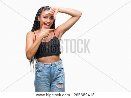 Young braided hair african american with pigmentation blemish birth mark over isolated background smiling making frame with hands and fingers with happy face. Creativity and photography concept.