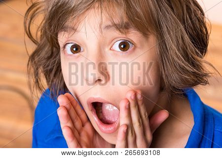 Emotional Portrait Of Excited Little Girl. Funny Cute Surprised Child 10 Year Old With Mouth Open In