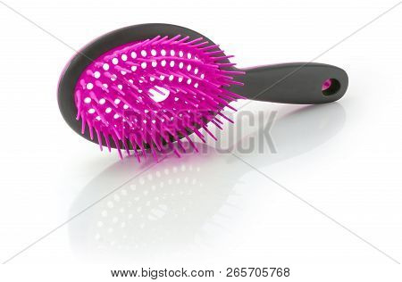 Gray With Pink Hairbrush With Plastic Bristles On A White Reflective Surface