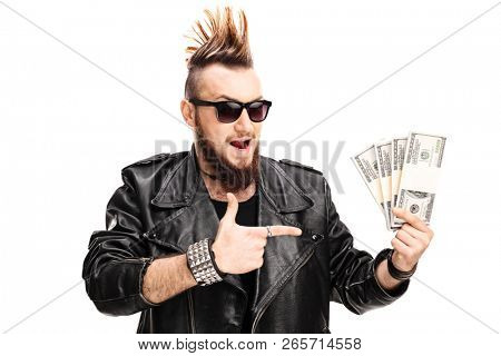 Punker in a leather jacket holding money and pointing isolated on white background