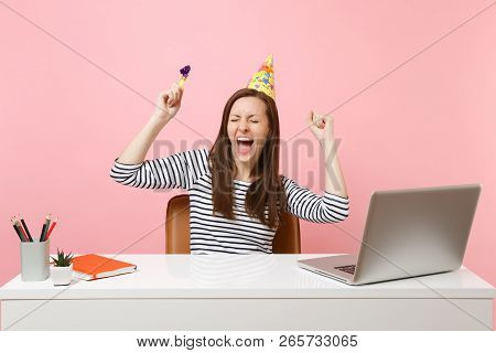 Cheerful Girl With Closed Eyes In Birthday Party Hat With Playing Pipe Screaming Celebrating While S